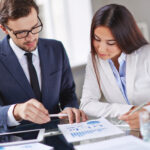 elegant executives reviewing report
