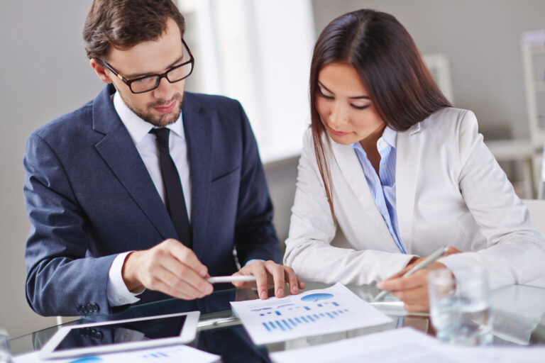 elegant executives reviewing report