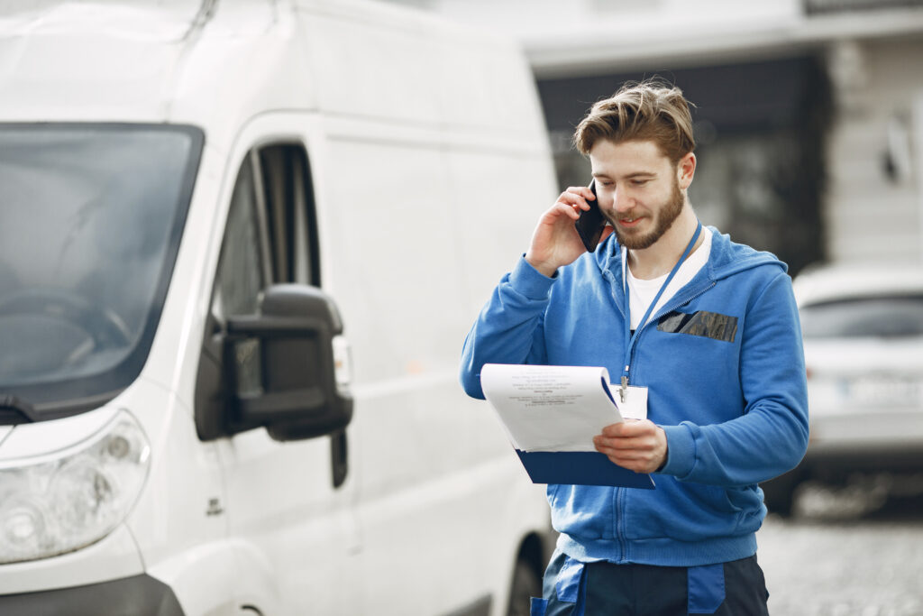 man by truck guy delivery uniform man with clipboard