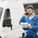 man by truck guy delivery uniform man with clipboard
